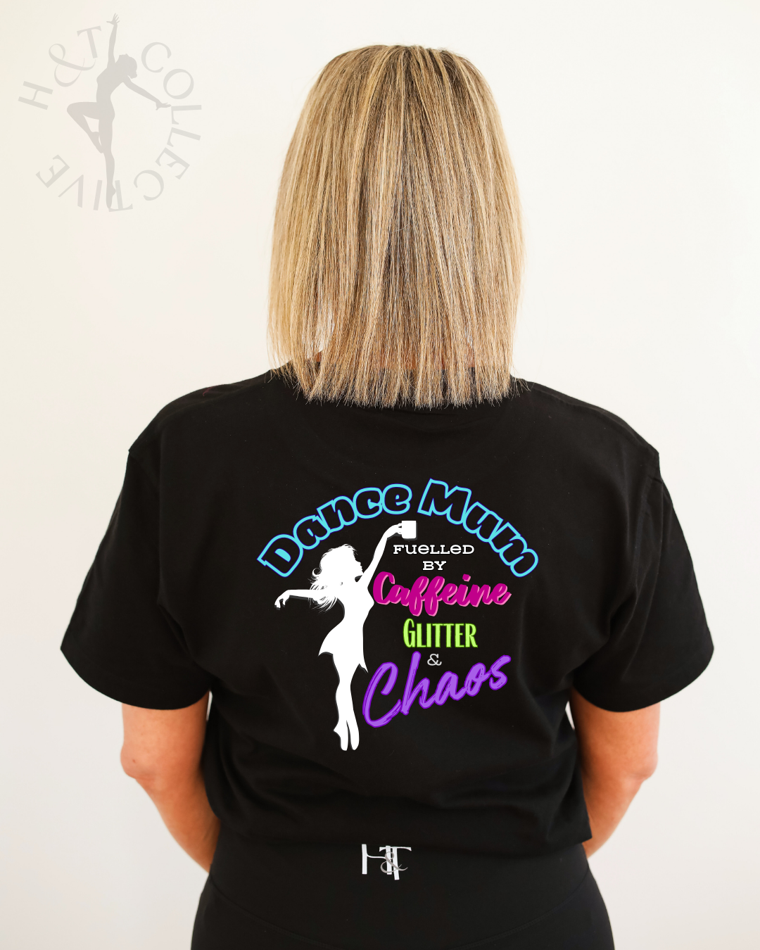 Person wearing a black t-shirt with a colorful graphic and text on the back.